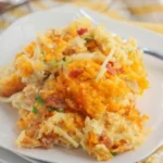 Creamy Crack Chicken Casserole topped with cheese and herbs