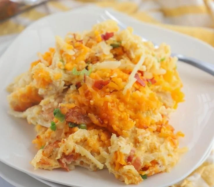 Creamy Crack Chicken Casserole topped with cheese and herbs