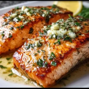 Pan seared salmon fillet with garlic butter sauce on a plate