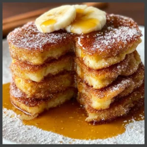 Delicious churro pancakes topped with chocolate sauce and cinnamon sugar