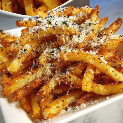 Plate of crispy truffle Parmesan fries garnished with herbs