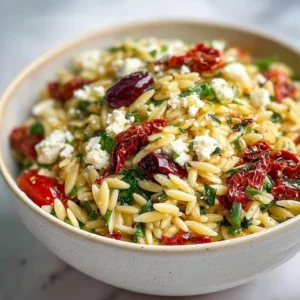 Homemade orzo pasta salad with feta cheese and sun-dried tomatoes